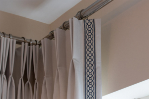 Plain cotton/linen fabric curtains in an off-white colour and matched it up with our navy braid.