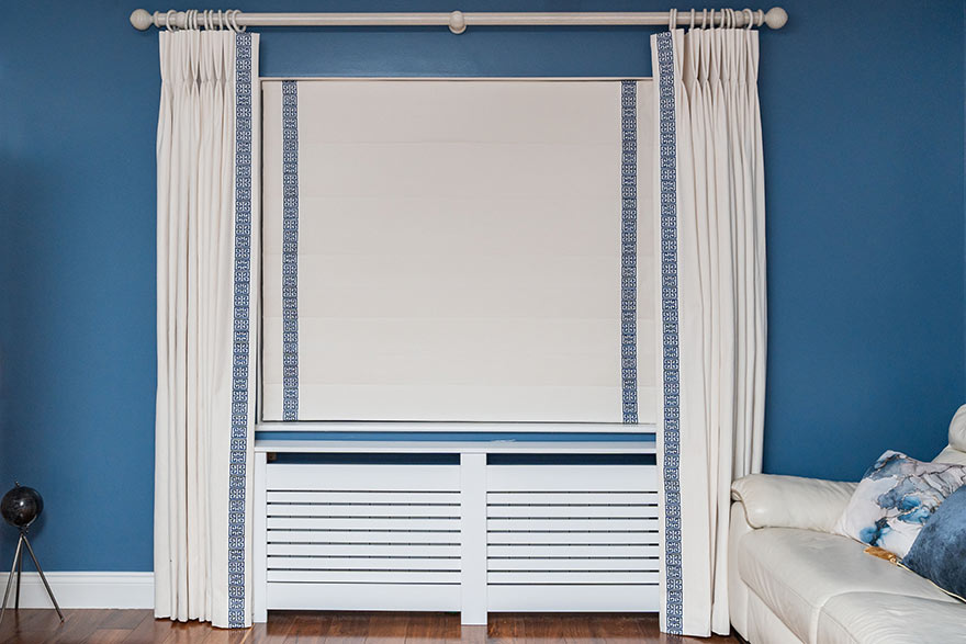 Stunning curtains and roman blinds in white with blue accents.